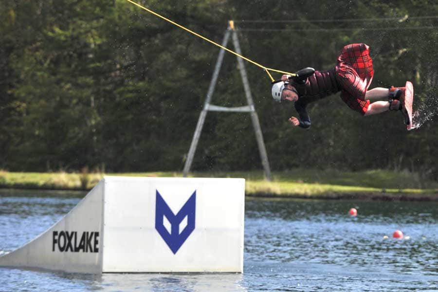 Wake boarding in a kilt at Foxlake Adventures.